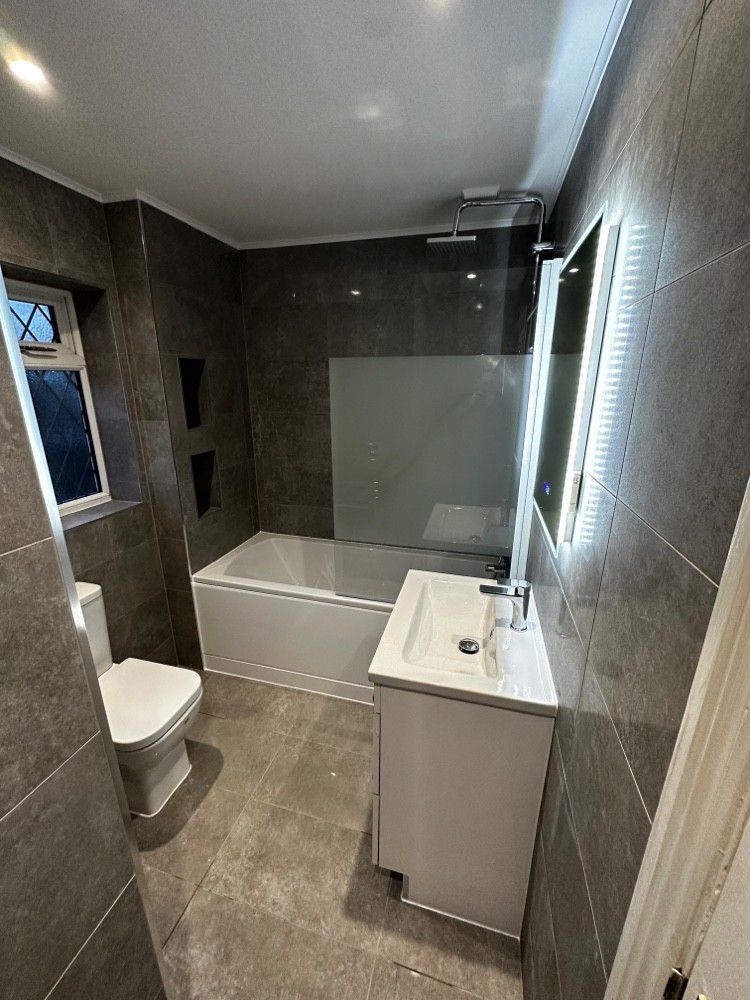 Modern bath with overhead rain shower and LED mirror