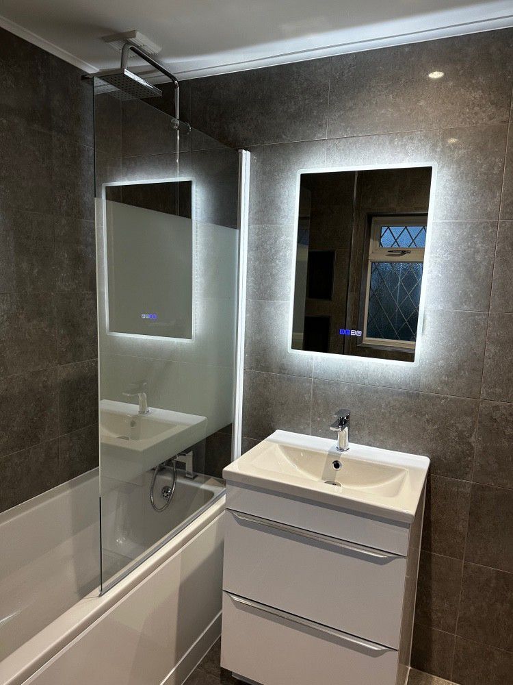 New vanity unit with backlit mirrors and chrome fixtures