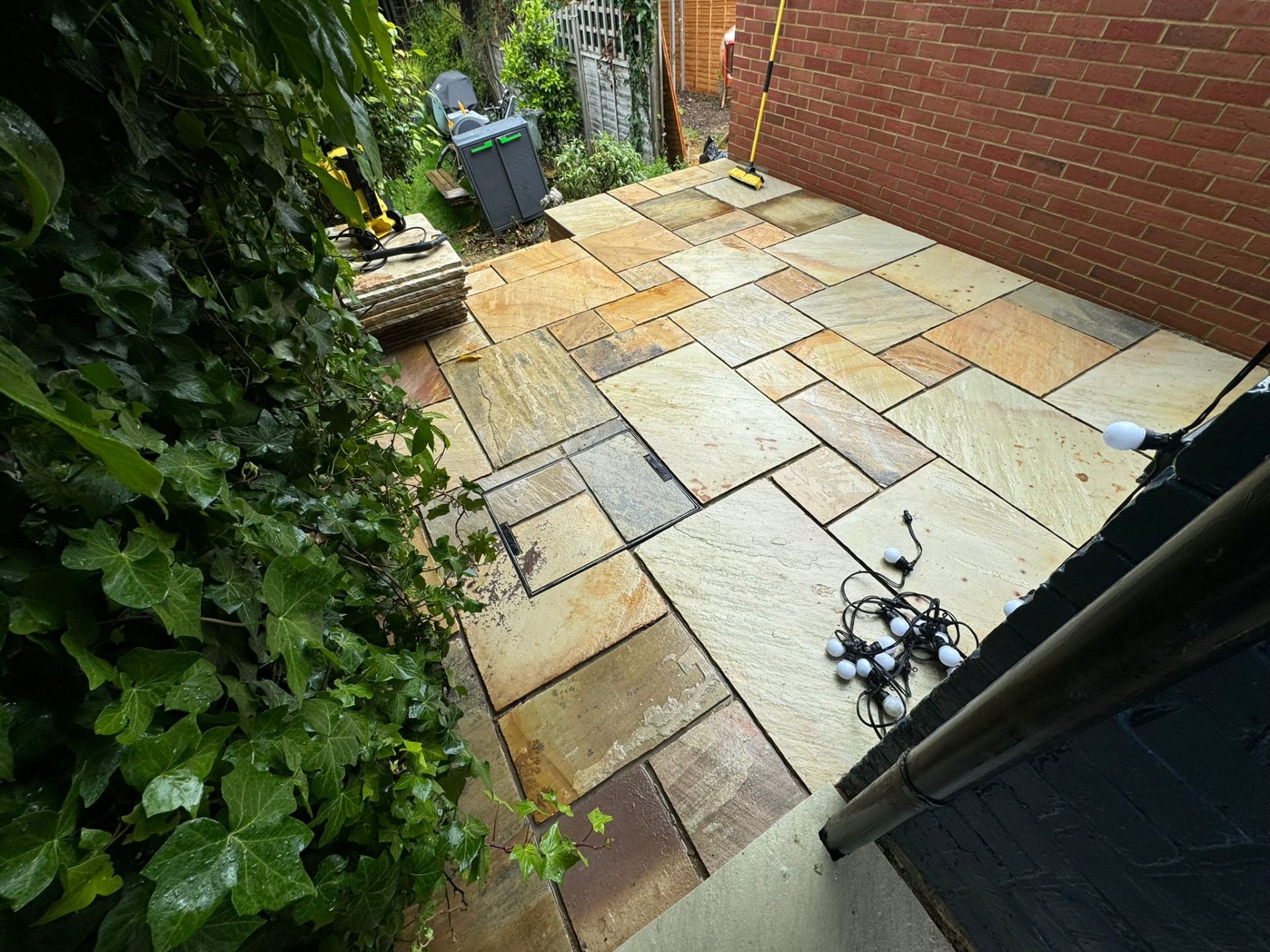 Finished sandstone patio laid against new brickwork