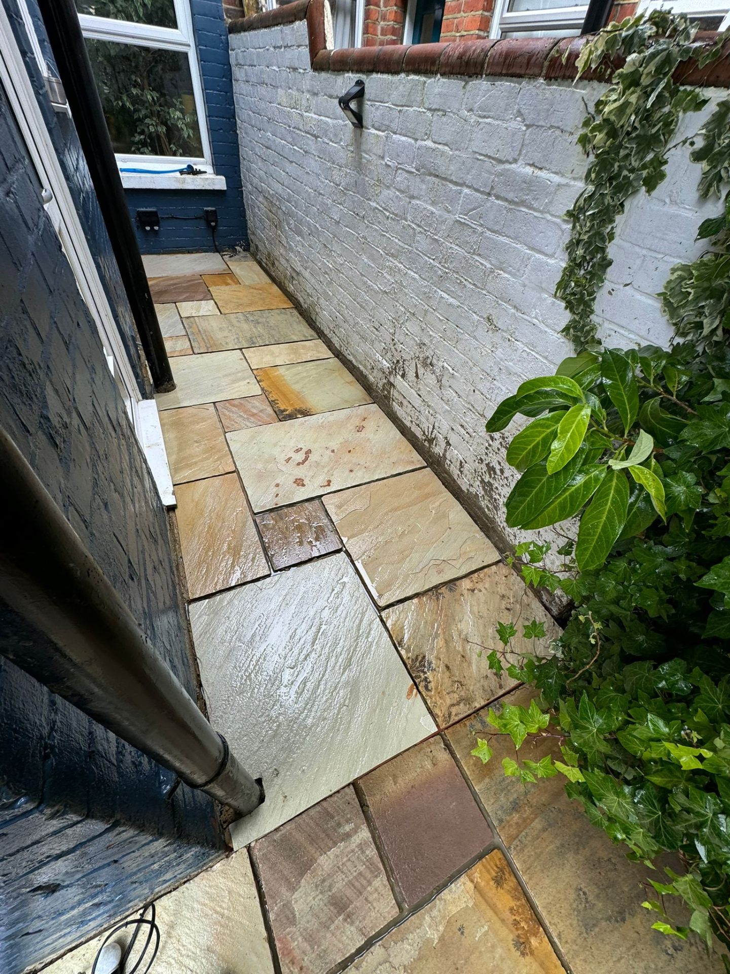Sandstone path running along the side of the property