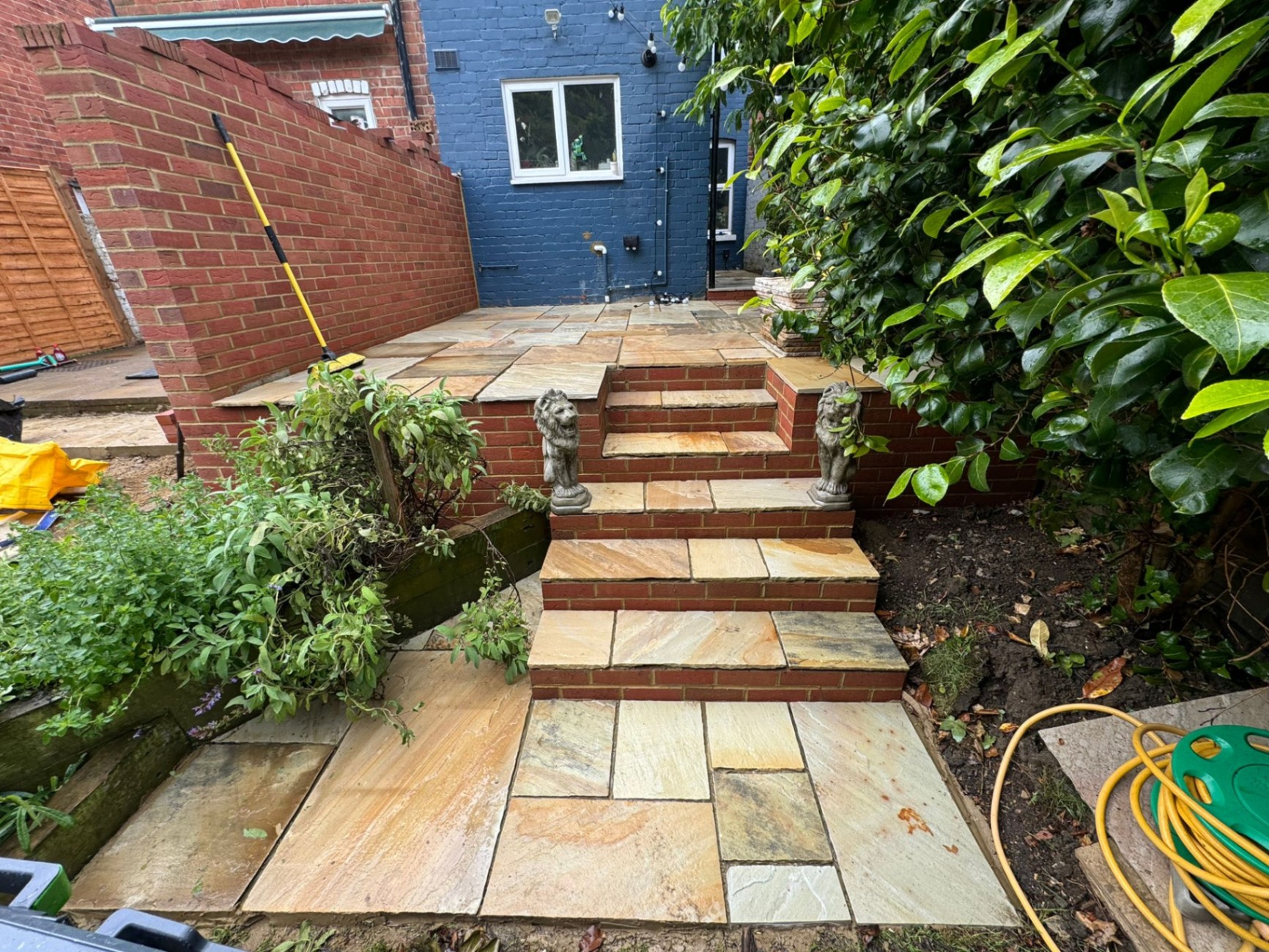 Completed sandstone steps with brick risers and lion statues