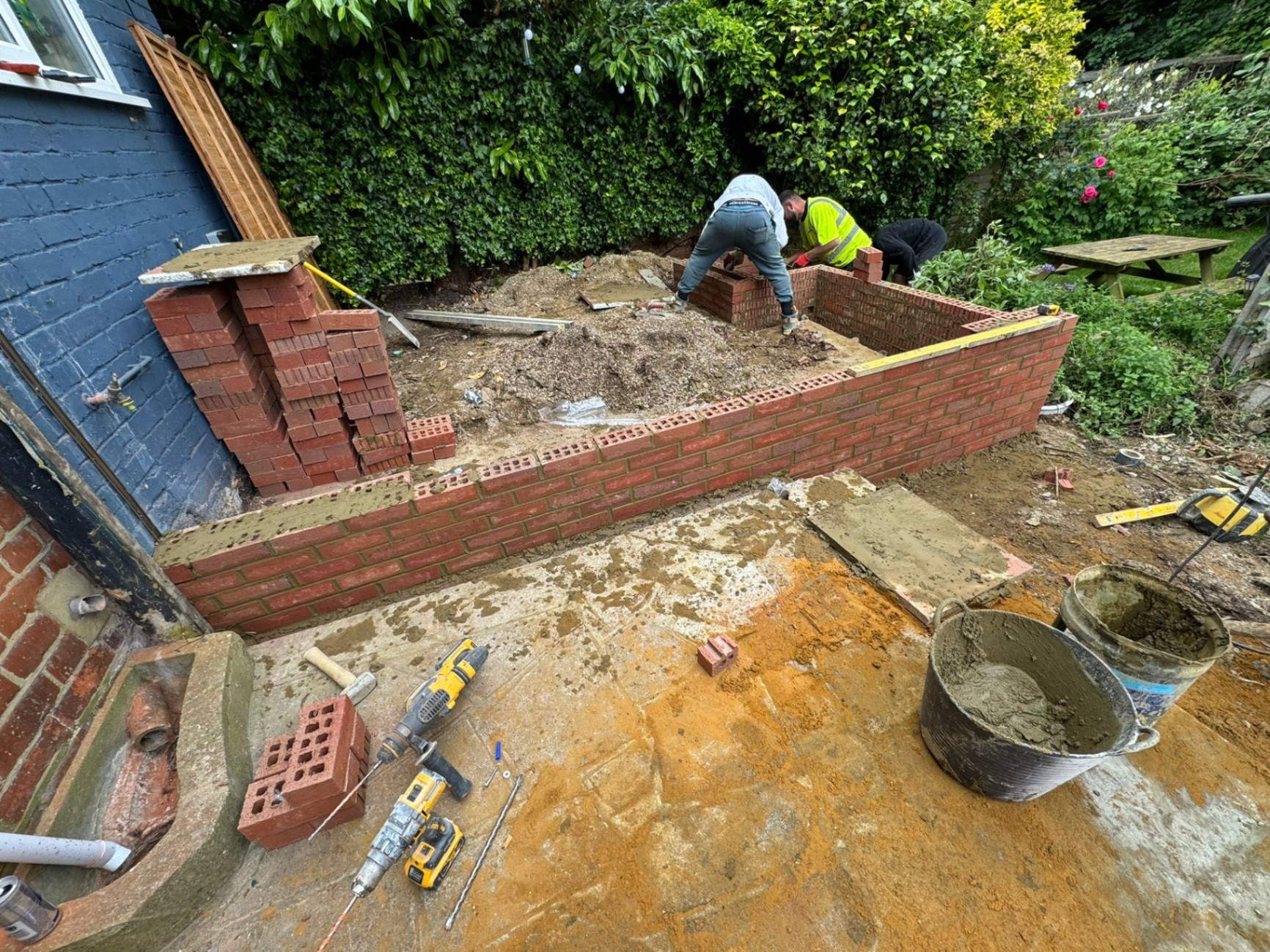 Foundation brickwork being laid for garden retaining walls